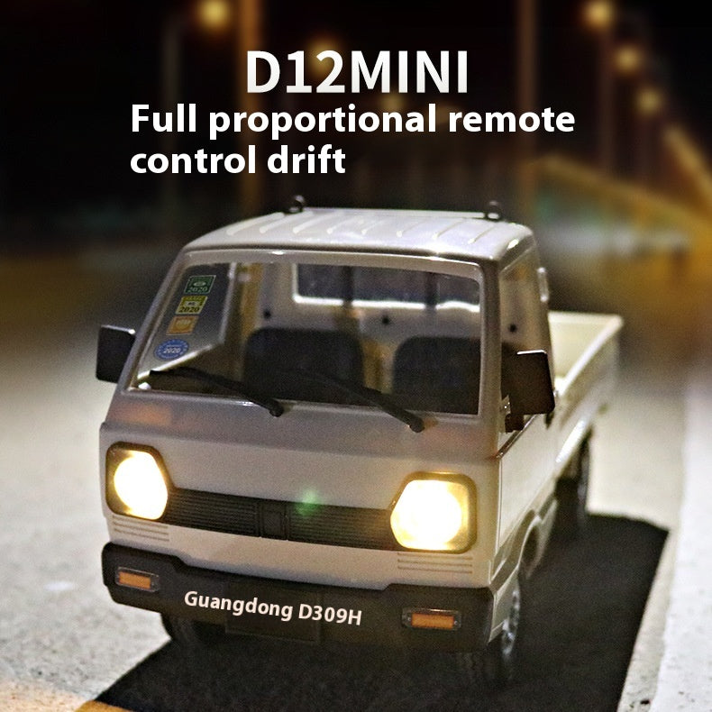 White D12 mini RC truck with headlights illuminated in a night driving scene