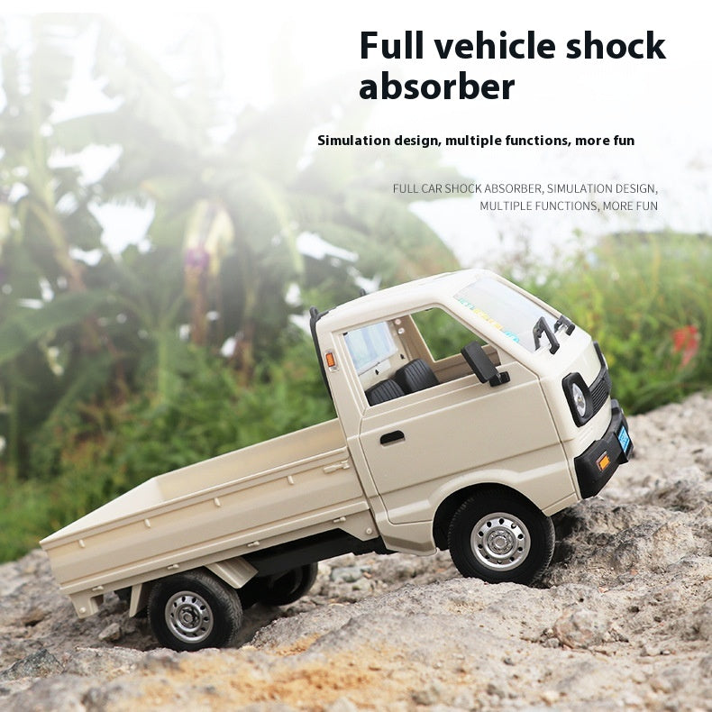 White 1:16 mini RC truck driving over rocks to demonstrate suspension movement