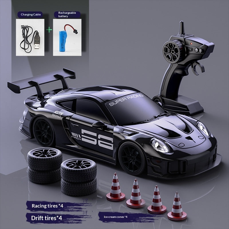 Black RC drift car set with remote control, racing tyres, drift tyres, cones and charging accessories